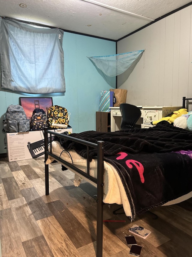 3092 S M 37, Baldwin, MI 49304 - bedroom with wood finished floors, a decorative wall, and a textured ceiling