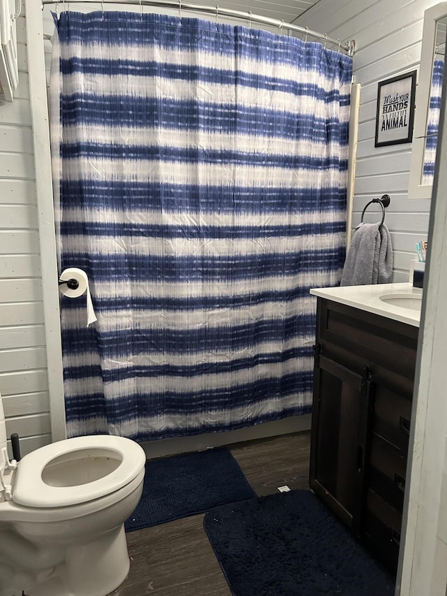 3092 S M 37, Baldwin, MI 49304 - bathroom with wood finished floors, wood walls, toilet, vanity, and a shower with shower curtain
