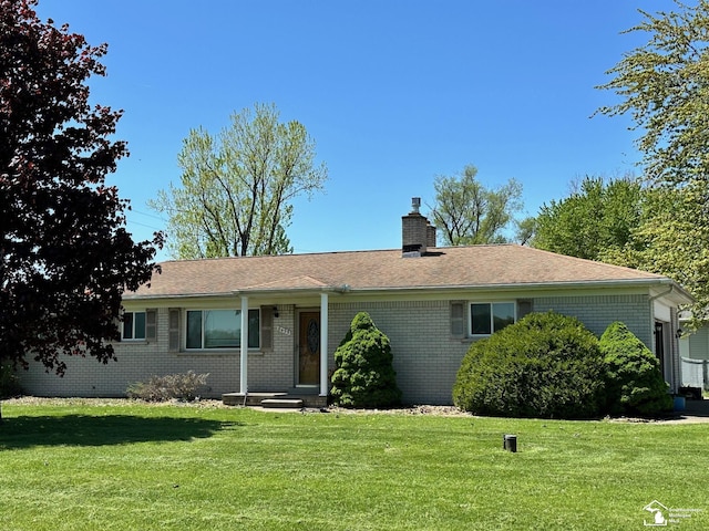 8499 Armstrong Rd, Newport, MI 48166 - single story home with a front lawn, brick siding, and a chimney