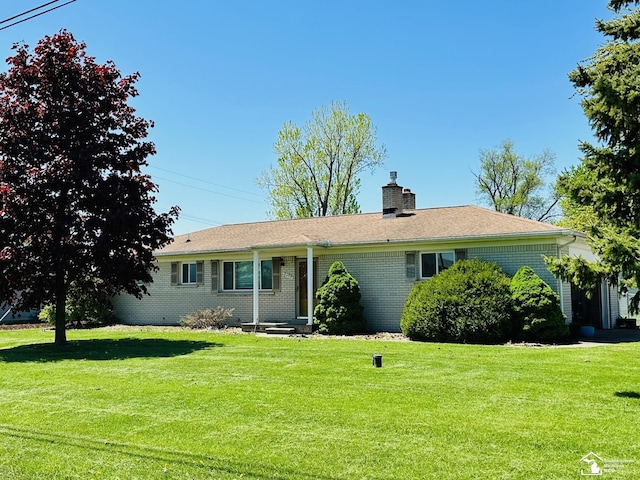 8499 Armstrong Rd, Newport, MI 48166 - ranch-style house with a chimney, a front lawn, and brick siding