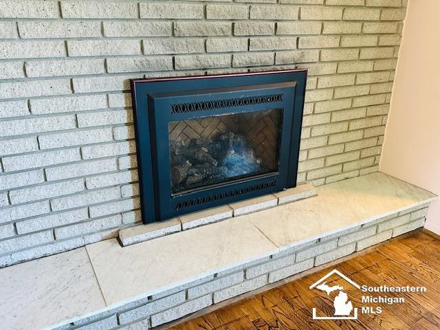 8499 Armstrong Rd, Newport, MI 48166 - detailed view of a fireplace and wood finished floors