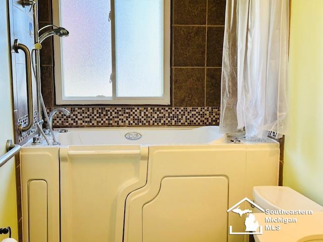 8499 Armstrong Rd, Newport, MI 48166 - bathroom featuring a tub and toilet