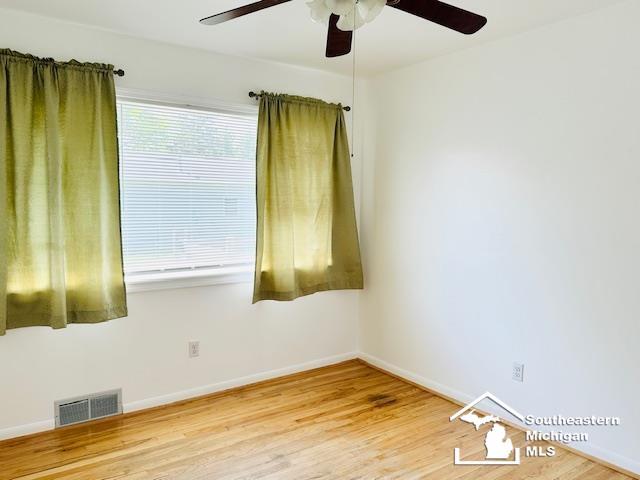 8499 Armstrong Rd, Newport, MI 48166 - empty room featuring a ceiling fan, wood finished floors, and baseboards