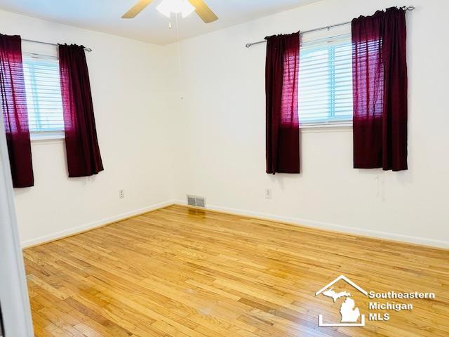 8499 Armstrong Rd, Newport, MI 48166 - empty room featuring wood finished floors, a ceiling fan, and baseboards