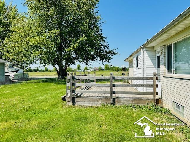 8499 Armstrong Rd, Newport, MI 48166 - view of green lawn featuring a wooden deck