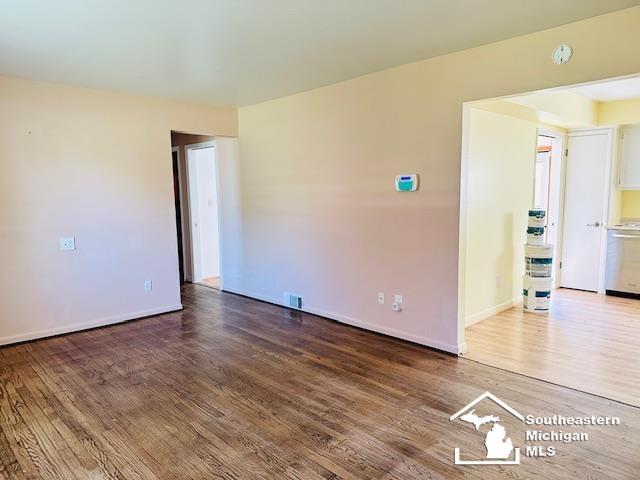 8499 Armstrong Rd, Newport, MI 48166 - empty room with wood finished floors, baseboards, and a smoke detector