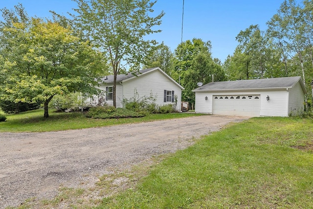 11478 E 7 Mile Rd, Tustin, MI 49688 - view of side of property with a lawn, an outbuilding, and a garage