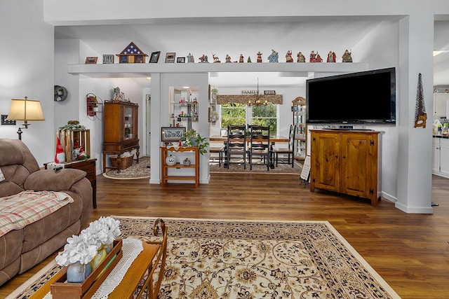 11478 E 7 Mile Rd, Tustin, MI 49688 - living area featuring wood finished floors and a chandelier