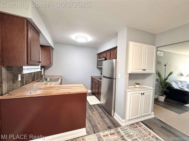 29240 Gloede Dr Unit 164, Warren, MI 48088 - kitchen featuring stainless steel appliances, a sink, butcher block counters, dark wood-style flooring, and white cabinets