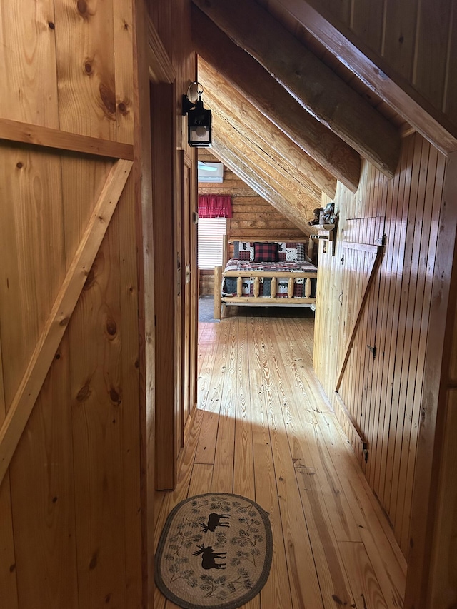 14278 Tyson Trl, Camden, MI 49232 - corridor with light wood-style floors and wooden walls