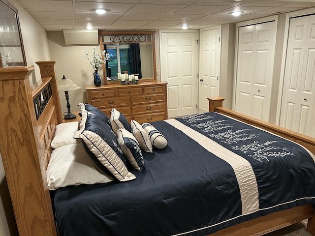 14278 Tyson Trl, Camden, MI 49232 - carpeted bedroom featuring two closets and a drop ceiling