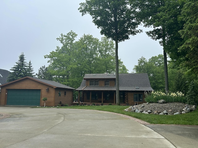 14278 Tyson Trl, Camden, MI 49232 - log cabin featuring a porch, a detached garage, log siding, and an outdoor structure