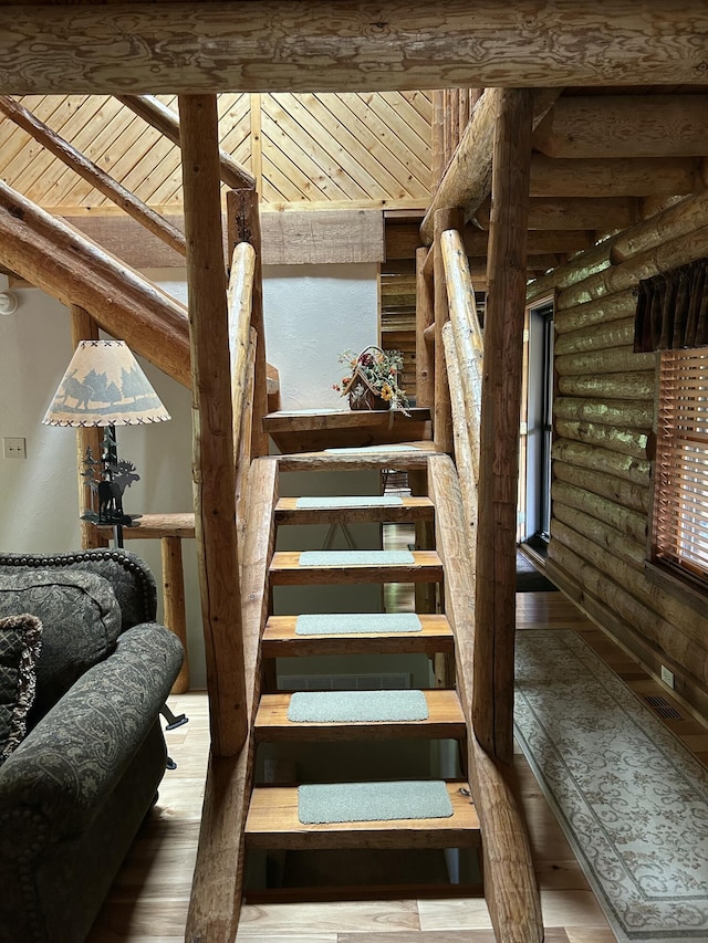 14278 Tyson Trl, Camden, MI 49232 - stairway with rustic walls, wood-type flooring, and wooden ceiling