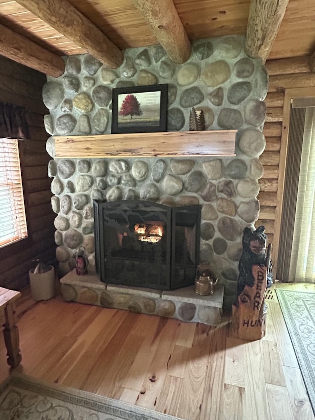 14278 Tyson Trl, Camden, MI 49232 - detailed view of rustic walls, wood ceiling with exposed beams, wood finished floors, and a fireplace