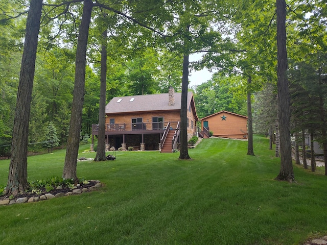 14278 Tyson Trl, Camden, MI 49232 - view of green lawn with a wooden deck and stairs