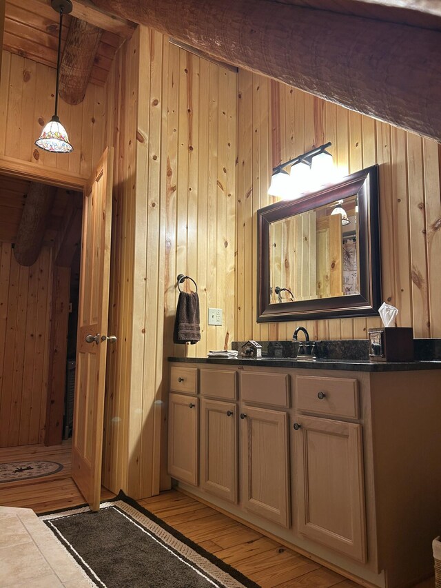 14278 Tyson Trl, Camden, MI 49232 - bathroom with wood walls, wood finished floors, and vanity