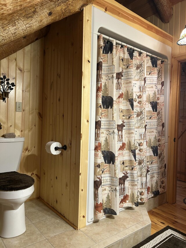 14278 Tyson Trl, Camden, MI 49232 - full bathroom featuring wooden walls, toilet, and a shower with shower curtain