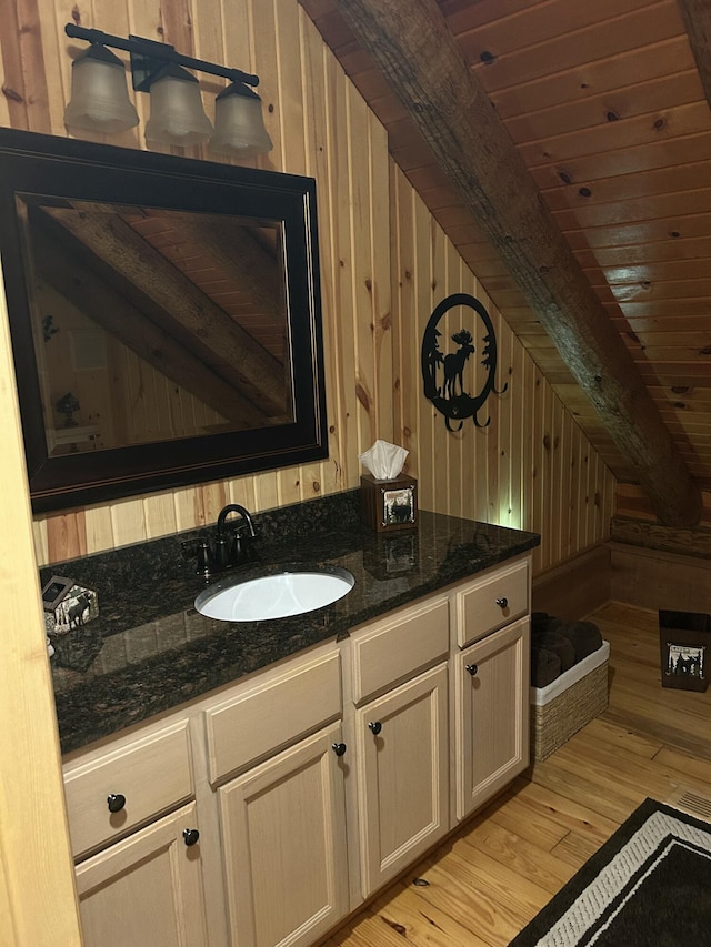14278 Tyson Trl, Camden, MI 49232 - bathroom featuring wood walls, wood-type flooring, vanity, and wooden ceiling with exposed beams
