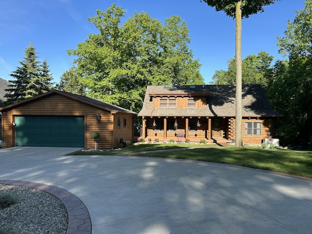 14278 Tyson Trl, Camden, MI 49232 - log home featuring a front yard, a shingled roof, covered porch, and log siding