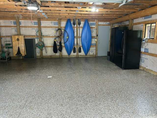 14278 Tyson Trl, Camden, MI 49232 - garage with freestanding refrigerator and a garage door opener