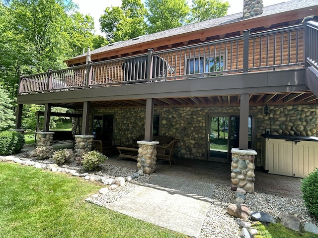 14278 Tyson Trl, Camden, MI 49232 - rear view of property with a patio area, a wooden deck, stone siding, and a chimney