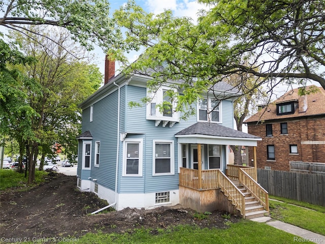 65 Melbourne St, Detroit, MI 48202 - traditional style home with a chimney, roof with shingles, and a porch