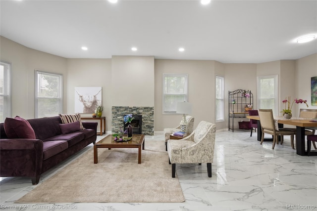65 Melbourne St, Detroit, MI 48202 - living area featuring healthy amount of natural light, recessed lighting, a stone fireplace, light marble finish flooring, and baseboards
