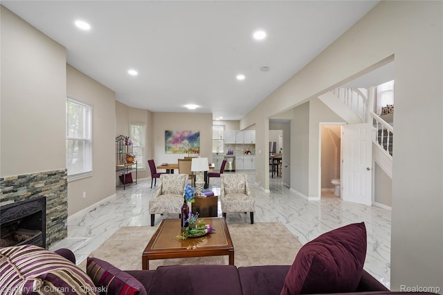 65 Melbourne St, Detroit, MI 48202 - living room featuring light marble finish flooring, stairway, recessed lighting, a stone fireplace, and baseboards