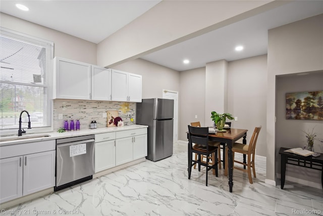 65 Melbourne St, Detroit, MI 48202 - kitchen featuring stainless steel appliances, a sink, light marble finish flooring, decorative backsplash, and light countertops