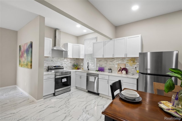 65 Melbourne St, Detroit, MI 48202 - kitchen featuring appliances with stainless steel finishes, wall chimney range hood, light marble finish flooring, white cabinetry, and recessed lighting