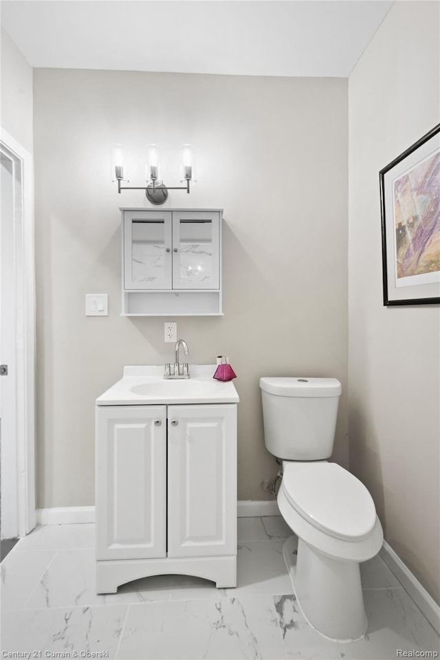 65 Melbourne St, Detroit, MI 48202 - bathroom featuring baseboards, marble look tiles, vanity, and toilet