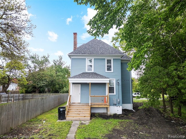 65 Melbourne St, Detroit, MI 48202 - back of house featuring a chimney, a shingled roof, and covered porch