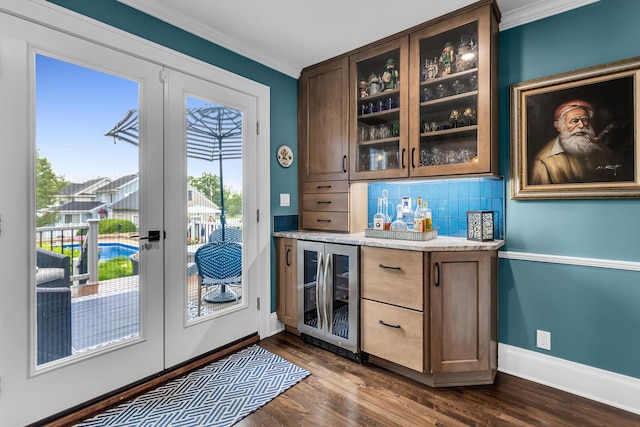 1406 W Washington Ave, Jackson, MI 49203 - indoor bar featuring wine cooler, ornamental molding, french doors, backsplash, and baseboards