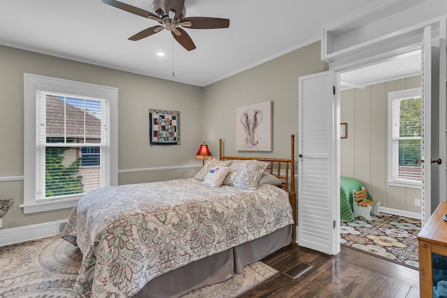 1406 W Washington Ave, Jackson, MI 49203 - bedroom featuring dark wood-type flooring, multiple windows, baseboards, and ceiling fan