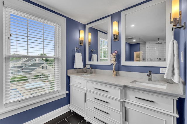 1406 W Washington Ave, Jackson, MI 49203 - bathroom featuring double vanity, baseboards, tile patterned flooring, healthy amount of natural light, and crown molding
