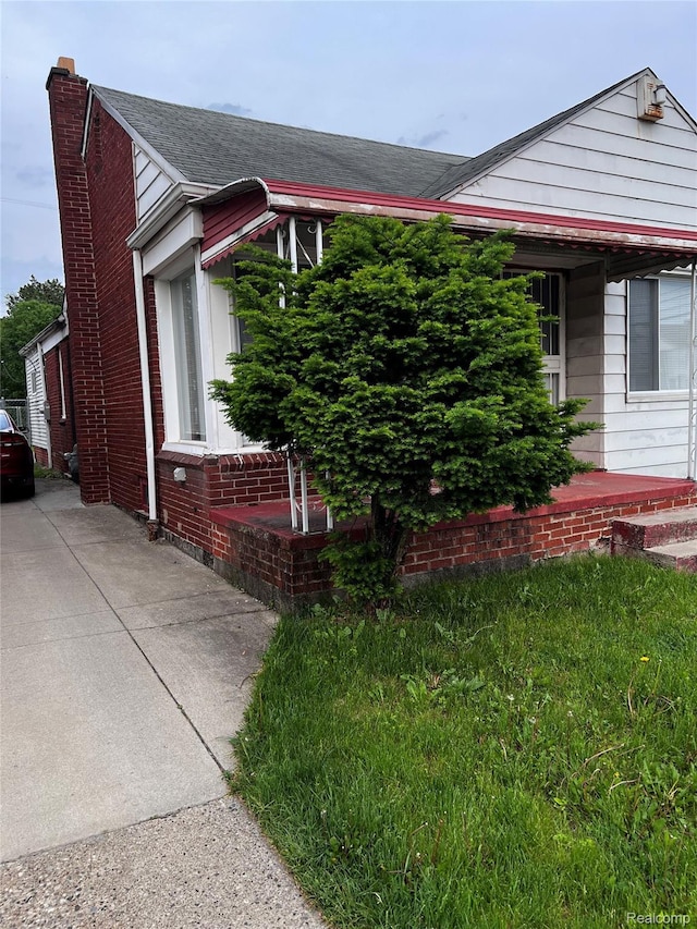 8208 Kentucky St, Detroit, MI 48204 - view of front of property featuring a chimney and brick siding