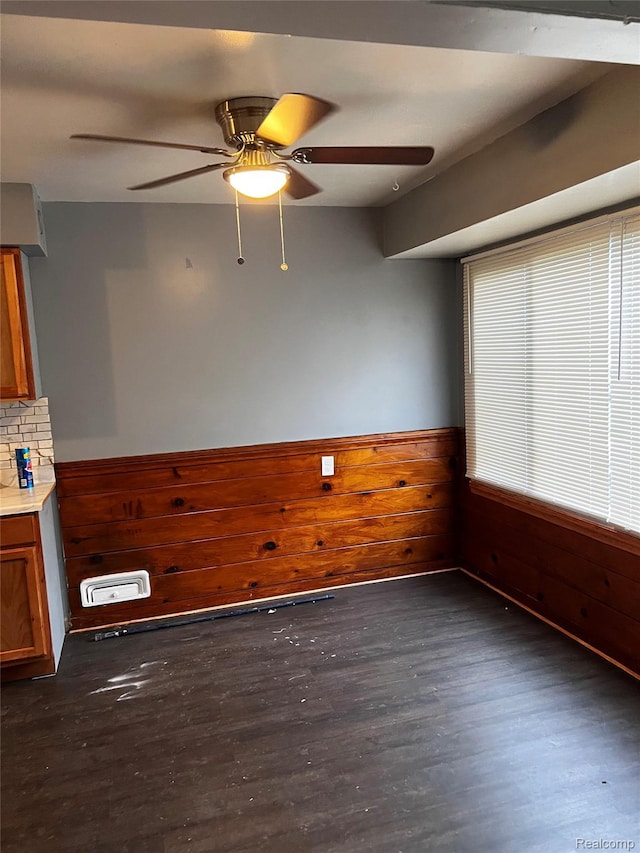 8208 Kentucky St, Detroit, MI 48204 - spare room with a ceiling fan, dark wood finished floors, wainscoting, and wood walls