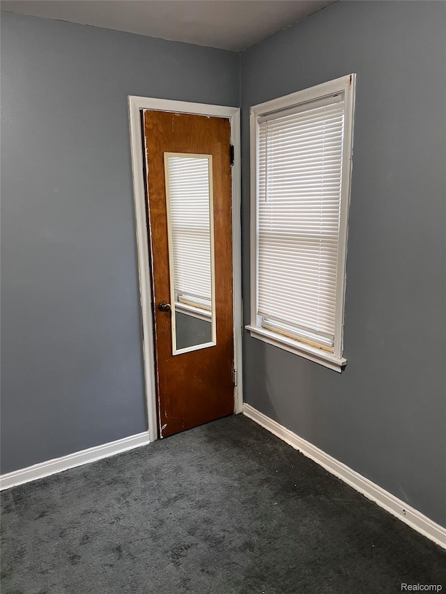 8208 Kentucky St, Detroit, MI 48204 - empty room with baseboards and dark carpet