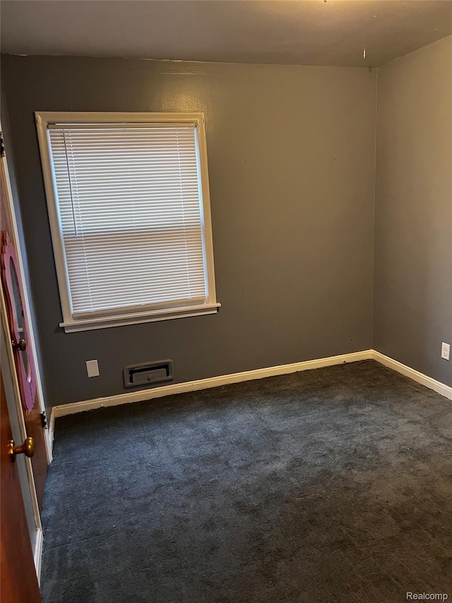 8208 Kentucky St, Detroit, MI 48204 - empty room featuring dark colored carpet and baseboards