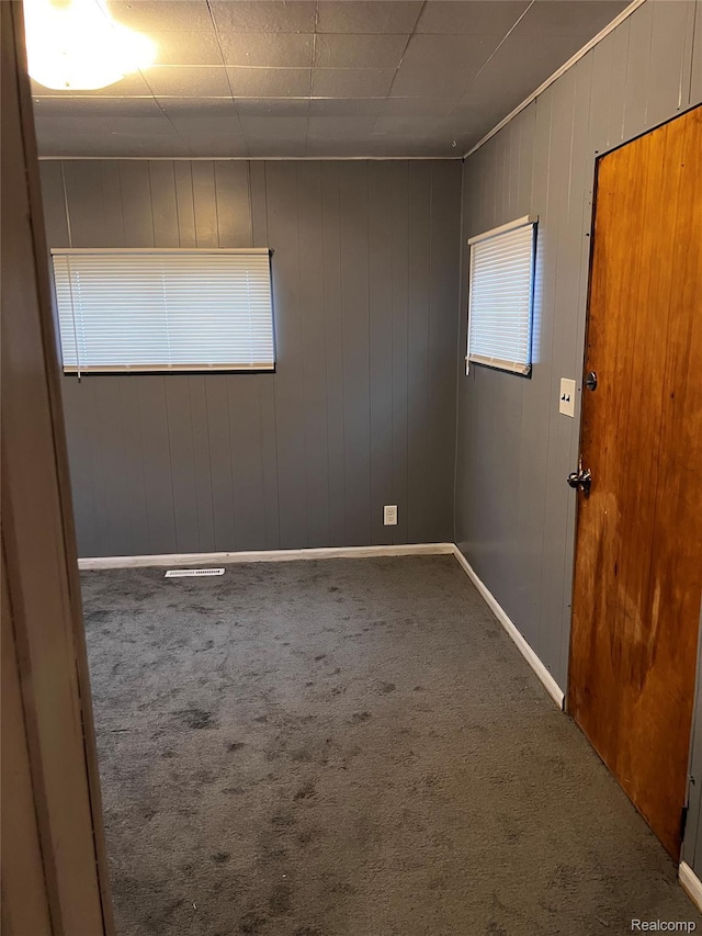 8208 Kentucky St, Detroit, MI 48204 - carpeted empty room featuring wooden walls and baseboards