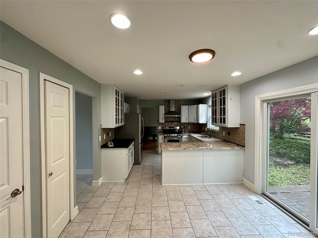 3758 Tienken Rd, Auburn Hills, MI 48326 - kitchen with wall chimney range hood, stainless steel range oven, a sink, tasteful backsplash, and glass insert cabinets