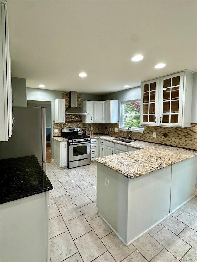 3758 Tienken Rd, Auburn Hills, MI 48326 - kitchen featuring appliances with stainless steel finishes, wall chimney exhaust hood, a sink, a peninsula, and tasteful backsplash