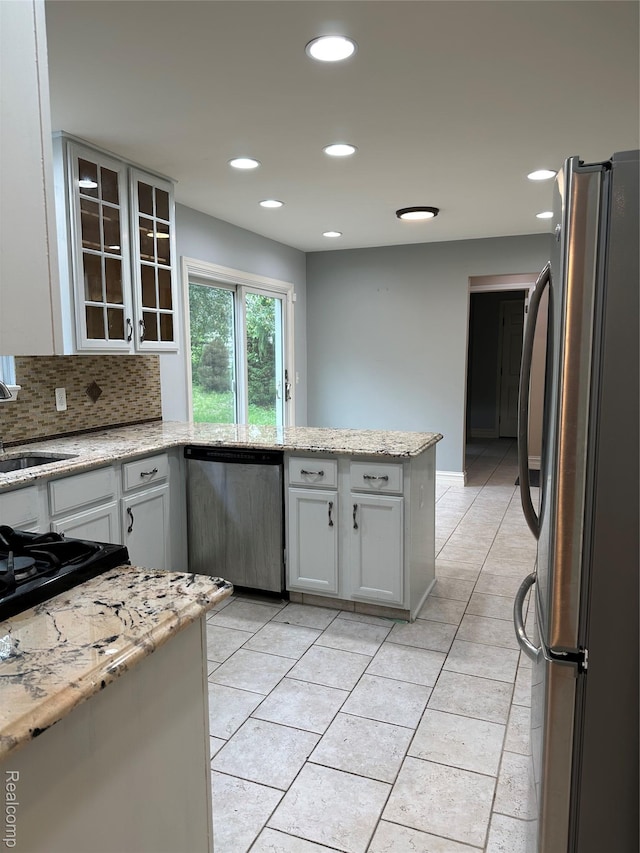 3758 Tienken Rd, Auburn Hills, MI 48326 - kitchen featuring stainless steel appliances, a sink, a peninsula, recessed lighting, and glass insert cabinets