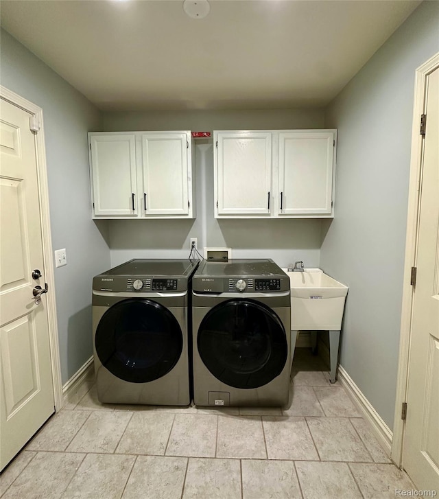 3758 Tienken Rd, Auburn Hills, MI 48326 - laundry area with cabinet space, washer and clothes dryer, and baseboards