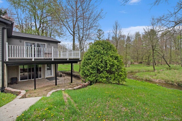 5315 Brown Rd, Millington, MI 48746 - view of grassy yard featuring a wooden deck and a patio
