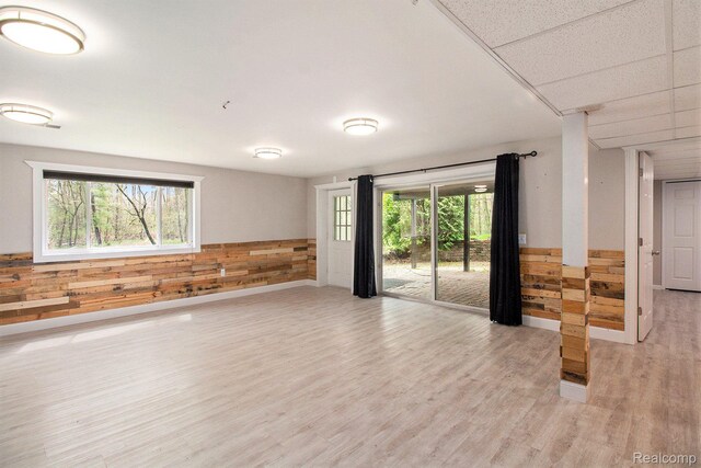 5315 Brown Rd, Millington, MI 48746 - spare room featuring light wood-style flooring, wood walls, and a wainscoted wall
