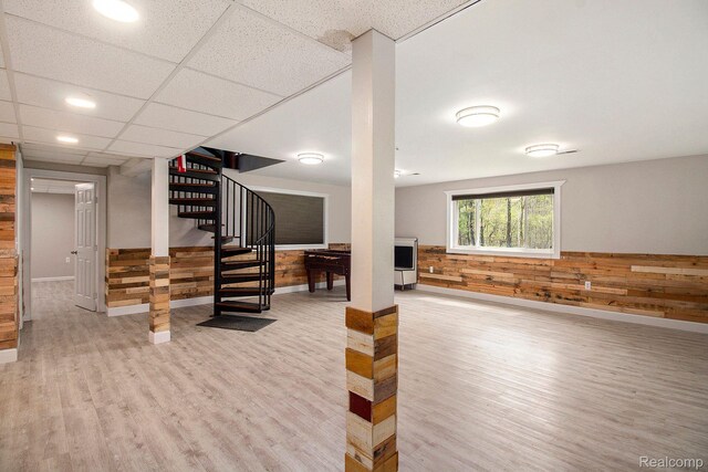 5315 Brown Rd, Millington, MI 48746 - below grade area featuring wood finished floors, wooden walls, stairway, baseboards, and wainscoting