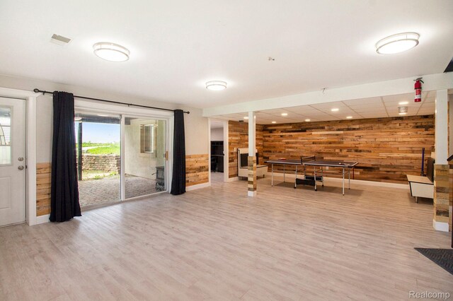 5315 Brown Rd, Millington, MI 48746 - unfurnished living room with wood walls, wood finished floors, and baseboards