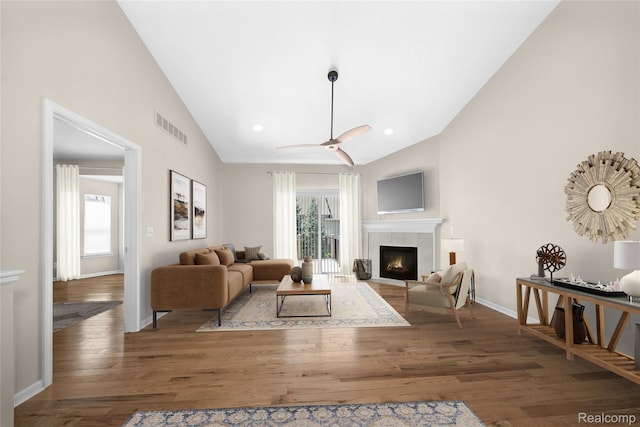 3021 Berkshire Rd, Auburn Hills, MI 48326 - living room featuring wood finished floors, baseboards, a fireplace, ceiling fan, and high vaulted ceiling