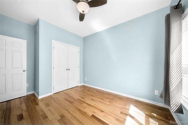 3021 Berkshire Rd, Auburn Hills, MI 48326 - unfurnished bedroom with wood finished floors, baseboards, a closet, and a ceiling fan